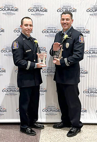 Pair receive bravery awards: Firefighters honored for rescuing three from burning home